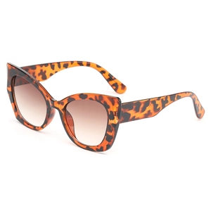 Classic tortoise shell cat eye sunglasses with brown gradient lenses on white background
