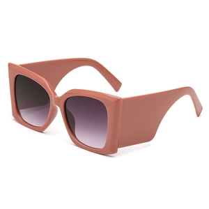 Fashionable oversized square sunglasses with red frames and purple gradient lenses