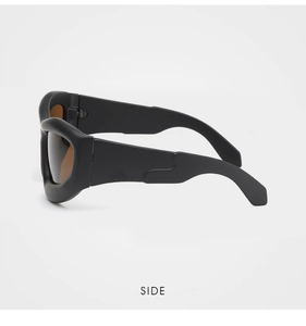 Side view of chunky black matte sunglasses with brown lenses and wavy frame design