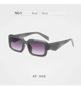 Gros plan de lunettes de soleil unisexes à monture gris foncé et verres dégradés violets