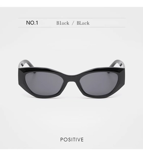 Front view of black thick frame cat-eye sunglasses with sharp retro geometric angles