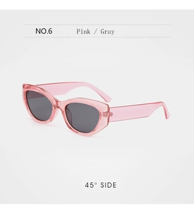 Close-up of pink transparent cat-eye sunglasses with dark gray lenses at a 45-degree angle