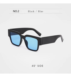 Detail view of square black sunglasses with blue lenses and wide temple design