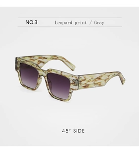Detail view of leopard print hip hop sunglasses with gray gradient lenses at 45-degree angle