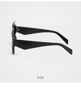 Side view detail of black oversized sunglasses with geometric diamond-cut carved temples
