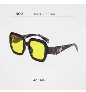Detail of square sunglasses with yellow lenses and purple marble patterned temples