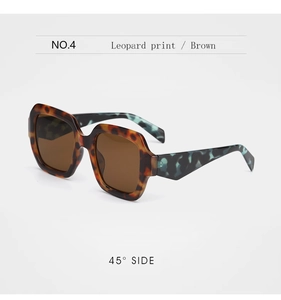 Detail of square leopard print sunglasses with blue marble temples and brown lenses