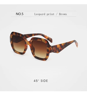 Detailed 45-degree side view of leopard print sunglasses with brown gradient lenses