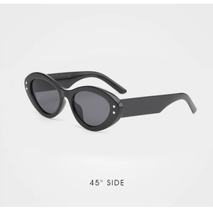 Detail of black cat-eye sunglasses featuring two silver star accents on wide side frame