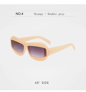 Close-up of chunky orange sunglasses frames with premium double gray gradient lenses