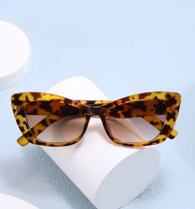 Close-up of leopard cat eye sunglasses with UV protection lenses on white stand
