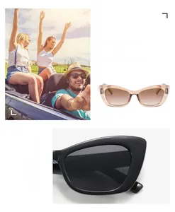 Detail view of small cat-eye sunglasses with translucent pink and classic black frames