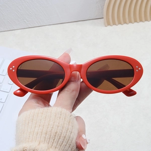 Retro red cat-eye sunglasses with silver dot accents and brown lenses for women