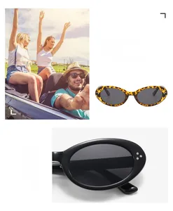 Close-up of tortoise shell and black oval sunglasses with silver decorative rivets