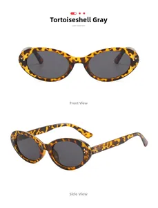 Detail view of oval cat-eye sunglasses with tortoiseshell frames and grey lenses