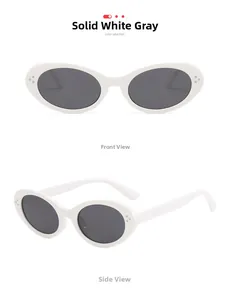 Detail view of oval white sunglasses with metal studs and dark grey lenses