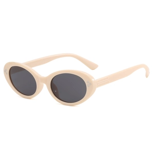Chic cream oval sunglasses with three-dot metal rivets and dark lenses from a 45-degree angle