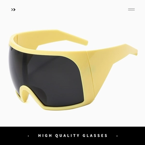 Macro shot of futuristic yellow oversized shield sunglasses with dark UV protection lenses