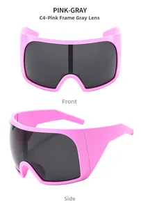 Close-up of pink oversized sunglasses with gray lenses and wide shield temples