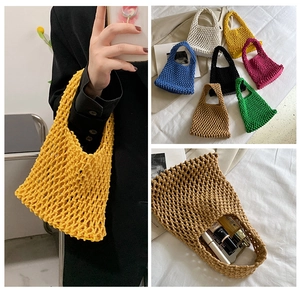 Detail of multi-color handmade woven cotton rope bags with mesh cutout structure