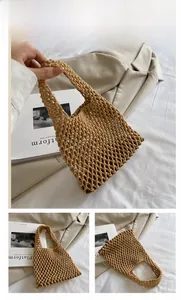Detailed close-up of khaki handmade crochet hollow knit tote bag with woven mesh texture