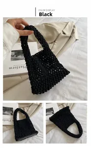 Detail of black handcrafted woven cotton rope bag featuring thick mesh net texture and handle