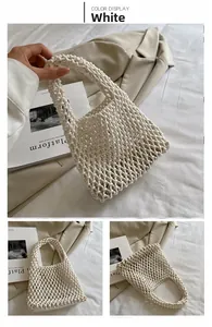 Close-up of white handmade cotton rope woven bag showing hollow mesh texture and handle