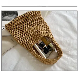 Close-up of khaki crochet tote bag showing interior storage capacity for cosmetics