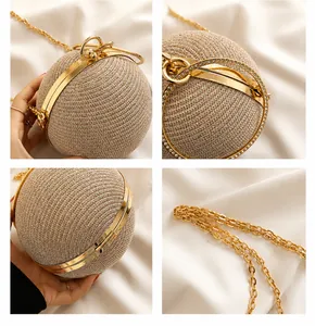 Detail of spherical rhinestone evening bag featuring gold metal frame and chain strap