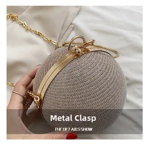 Detailed macro view of the silver woven texture and golden ring handle of a spherical bag