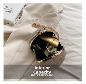 Detail view of champagne gold glitter evening bag interior with black lining and gold chain