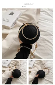 Detail of a black spherical evening bag with rhinestone accents and golden metal ring handle
