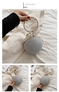 Detail of silver spherical evening clutch with sparkling rhinestones and metal ring handle