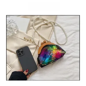 Detail of colorful sequin evening clutch with pearl chain and vintage wooden frame clasp