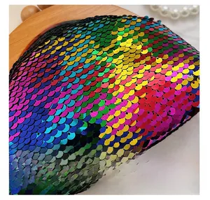 Detailed close-up of rainbow sequin texture on shell bag with natural wood frame accents