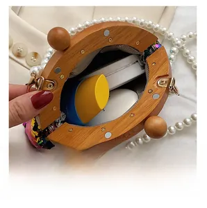 Detailed view of sequined evening bag interior with wood frame and pearl strap