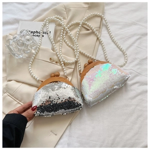 Detail of silver and iridescent white sequin clutch bags with wood bead clasp and pearl strap
