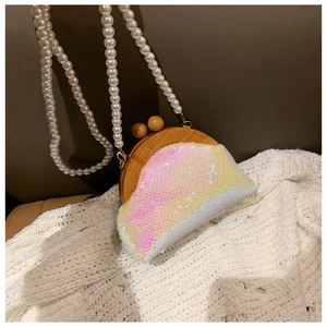 Detail of shell-shaped evening bag with iridescent sequins, wood frame, and pearl chain