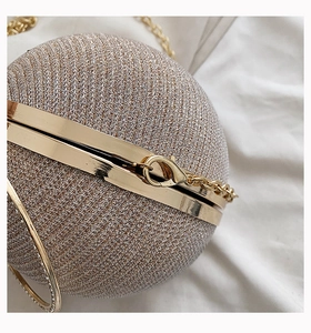 Macro detail of champagne gold sphere evening bag with glitter and metal clasp