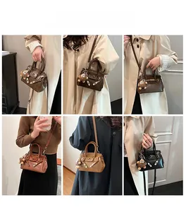 French style handbag in brown and black leather with cute plush bear charms shown on model