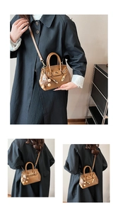 Detail of a brown mini satchel featuring a cute teddy bear charm and metal buckle