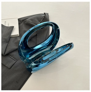Macro detail of electric blue metallic clutch with unique hollow round handle design