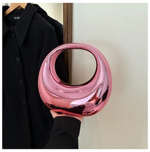 Close-up of pink mirror finish acrylic hobo bag with a sleek crescent moon shape