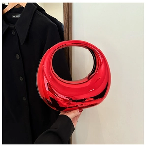 Macro shot of red metallic crescent acrylic evening bag with hollow circular handle