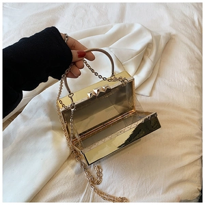Detailed interior view of a gold mirror acrylic evening box bag with metal chain