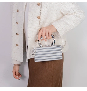 Silver mirror acrylic evening clutch with vertical relief stripes and metal handle