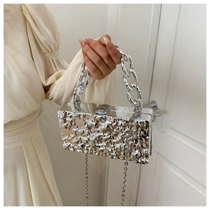 Detailed view of silver acrylic box bag with molten metal texture and chunky chain