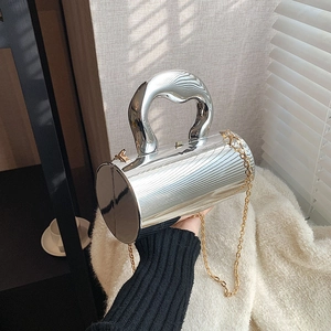 Silver metallic cylindrical evening bag with gold chain strap and mirror finish