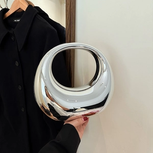 Modern acrylic evening clutch with a polished silver mirror finish and circular ring design