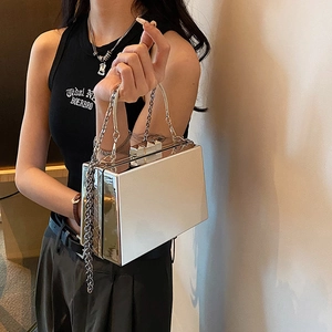 Silver metallic acrylic clutch bag with chain strap and mirror finish for evening wear